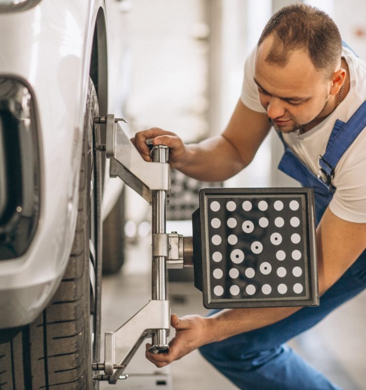 Auto mechanic checking car